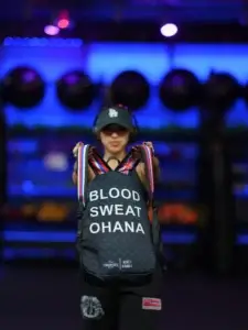 Gym-goer holding a Blood Sweat Ohana backpack at Maui Powerhouse Gym in Kīhei